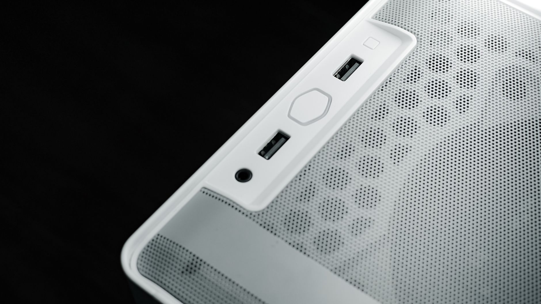 Detailed view of USB and audio ports on a white computer case, showcasing modern technology design.