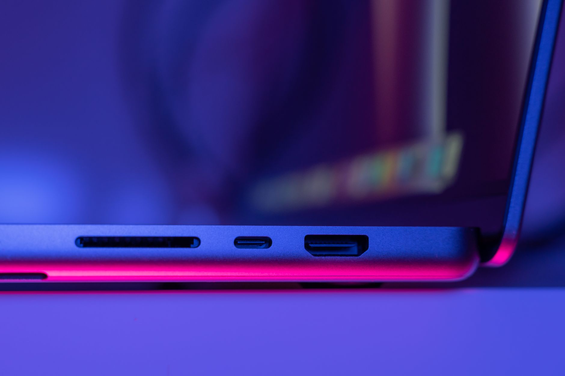 A close-up image of laptop ports highlighting modern technology with striking neon lighting.