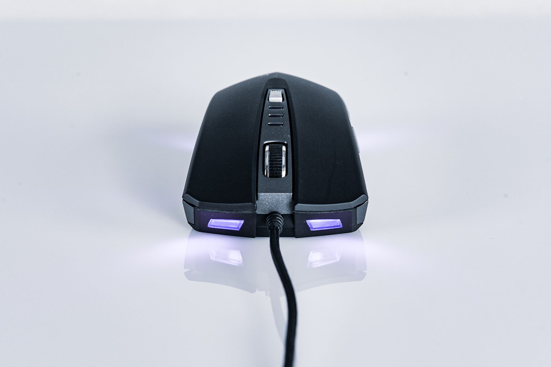 Close-up of a sleek, wired gaming mouse with LED lighting. Perfect for tech and gaming needs.