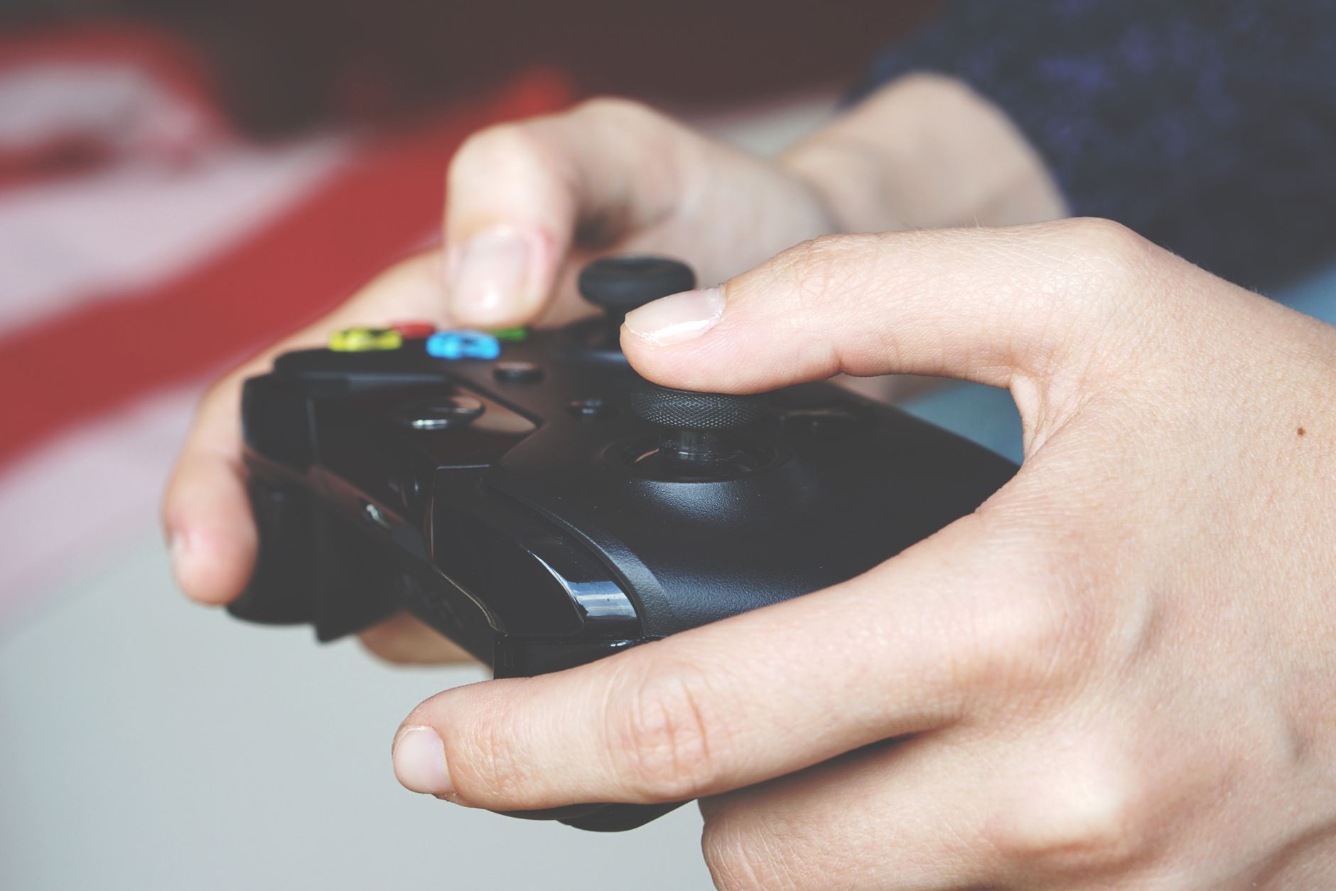 Close-up image of hands gripping an Xbox game controller depicting immersive gaming technology.
