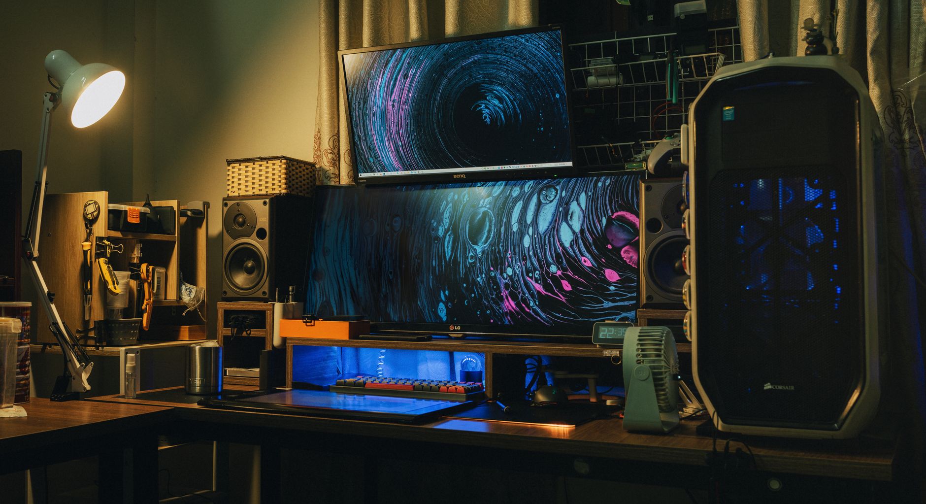 Contemporary home studio equipped with huge monitors and acoustic system placed on computer desk in room with electric lights