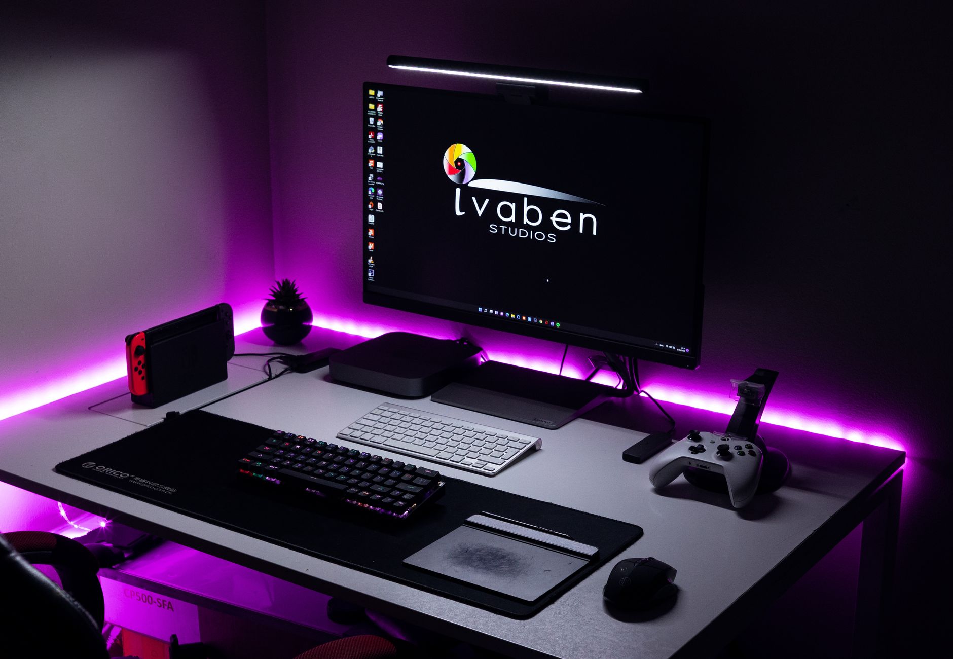 A stylish gaming area featuring LED lighting, gaming console, and modern peripherals.