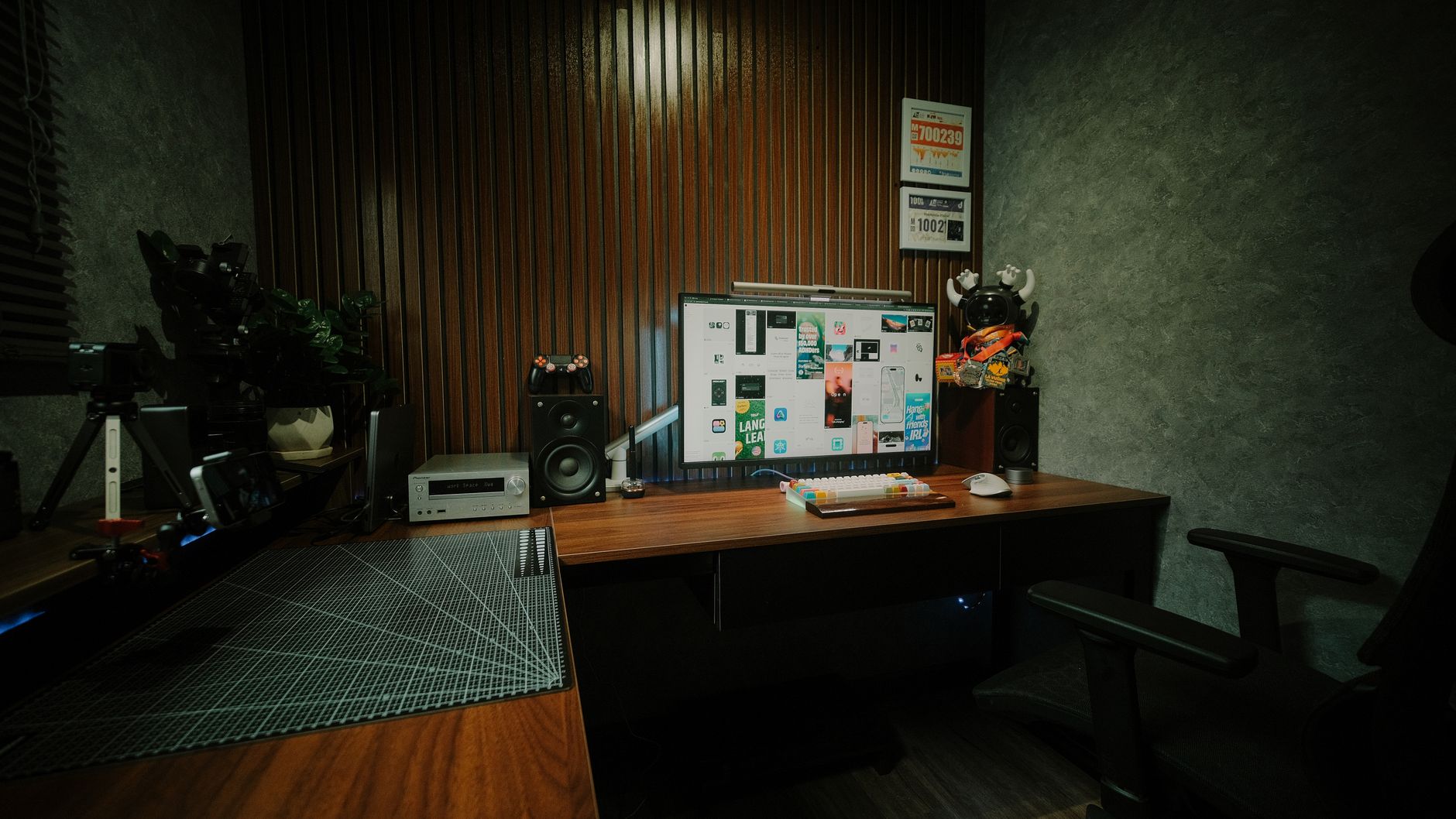 Cozy indoor workspace featuring dual monitors, speakers, and mood lighting.