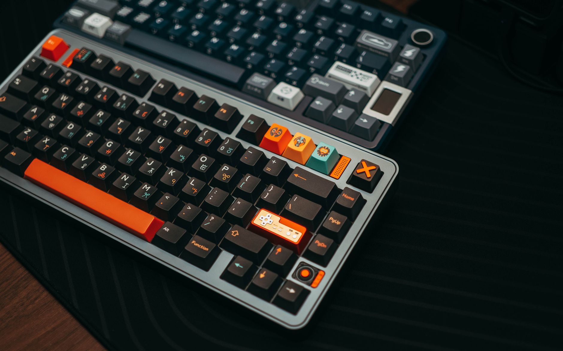 Close-up of colorful mechanical keyboards on a desk, showcasing unique keycaps and modern design.