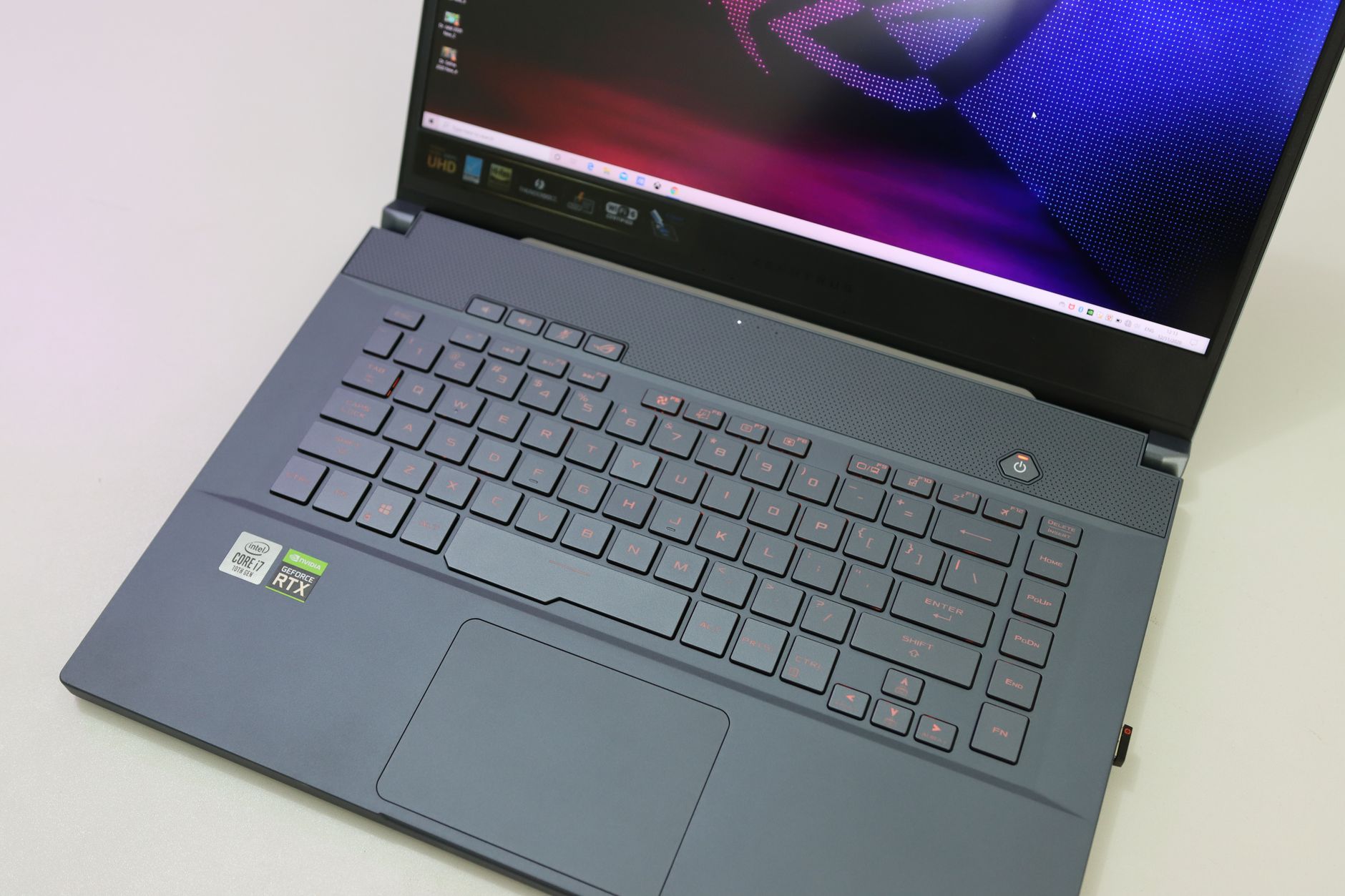 Close-up image of a laptop featuring a backlit keyboard and vibrant screen display.
