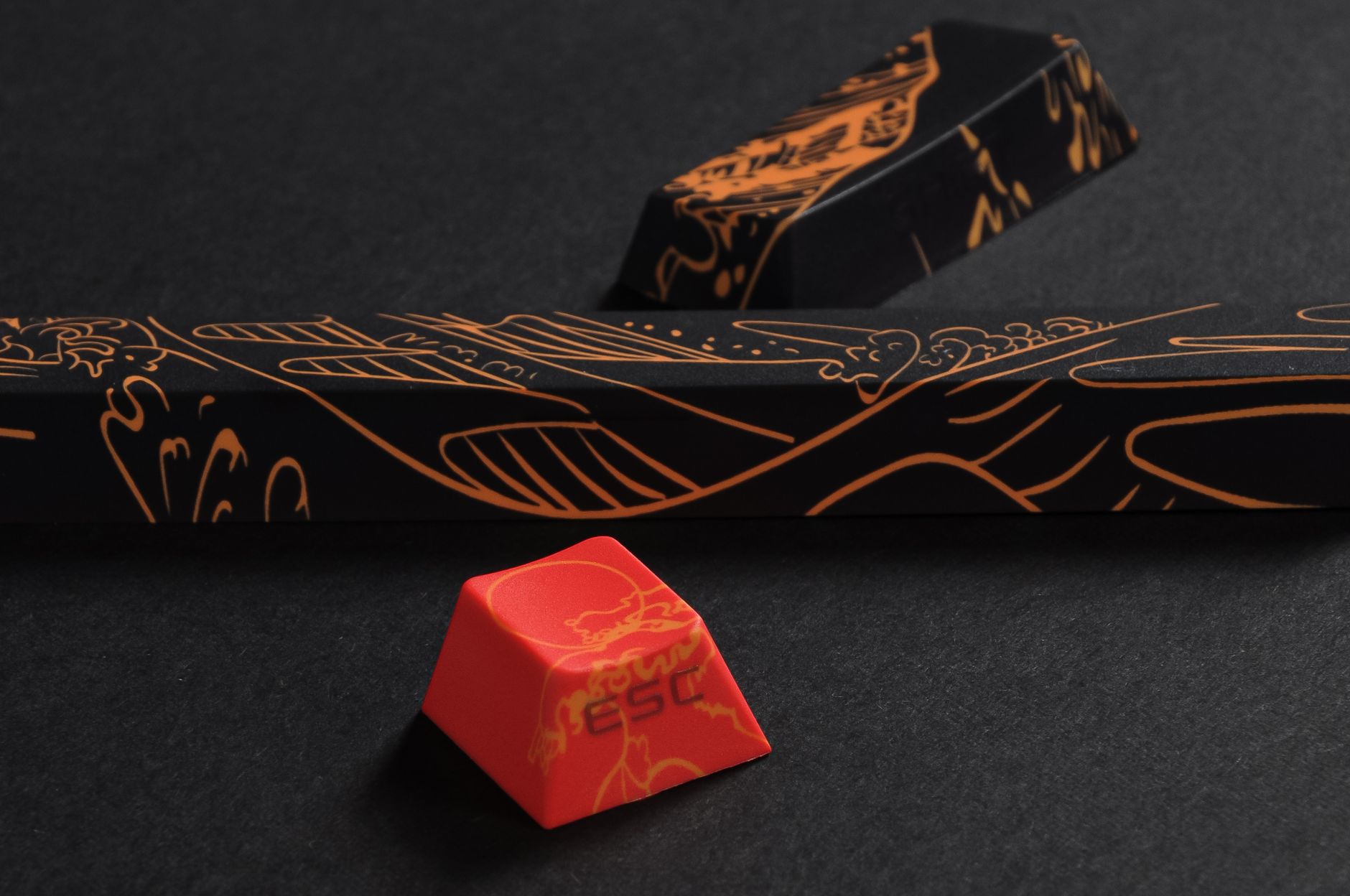 Detailed view of custom keycaps with intricate designs on a black background, featuring an ESC keycap.