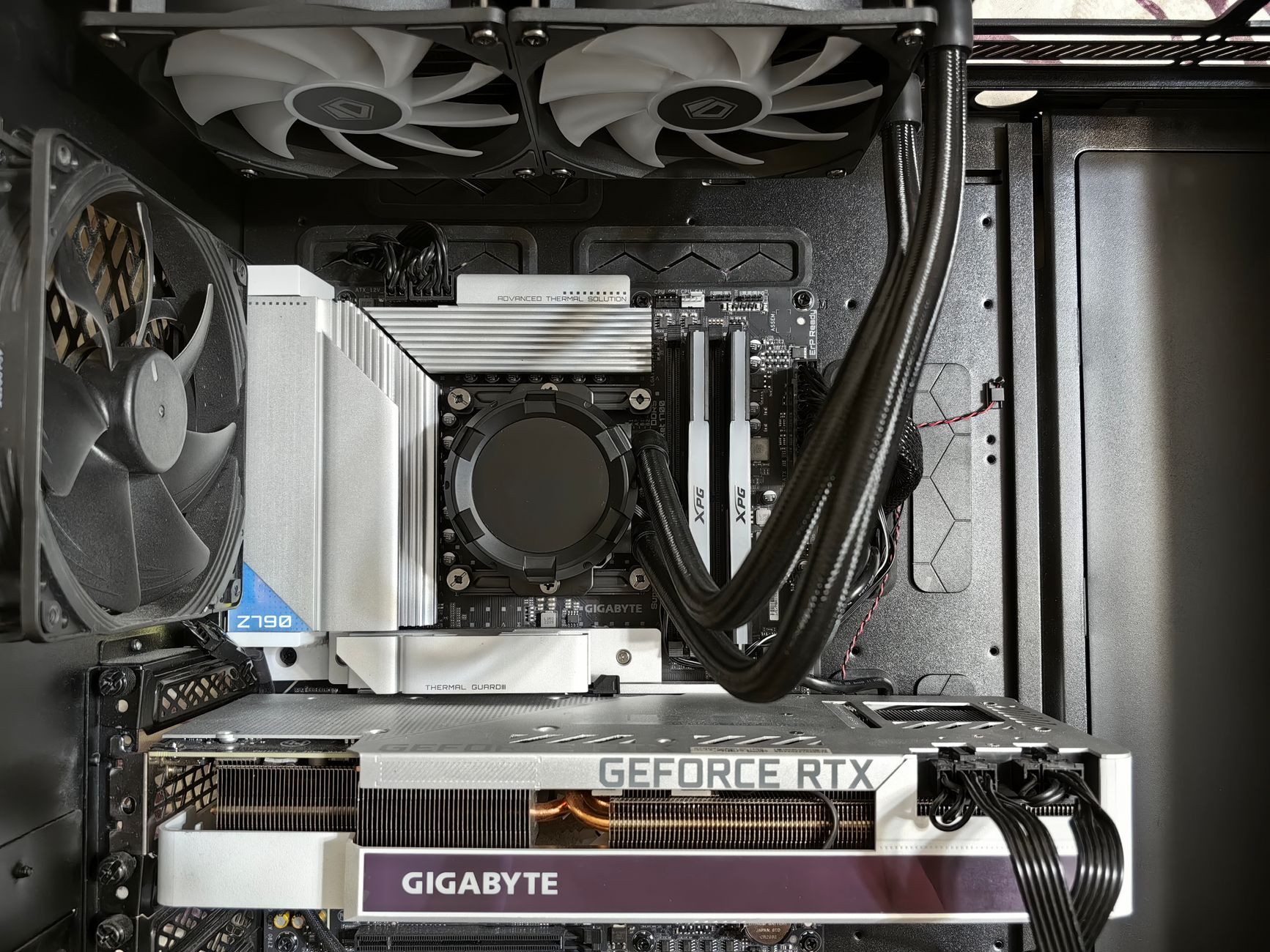 Detailed view of a custom gaming PC's interior showcasing components like RTX GPU and advanced cooling system.