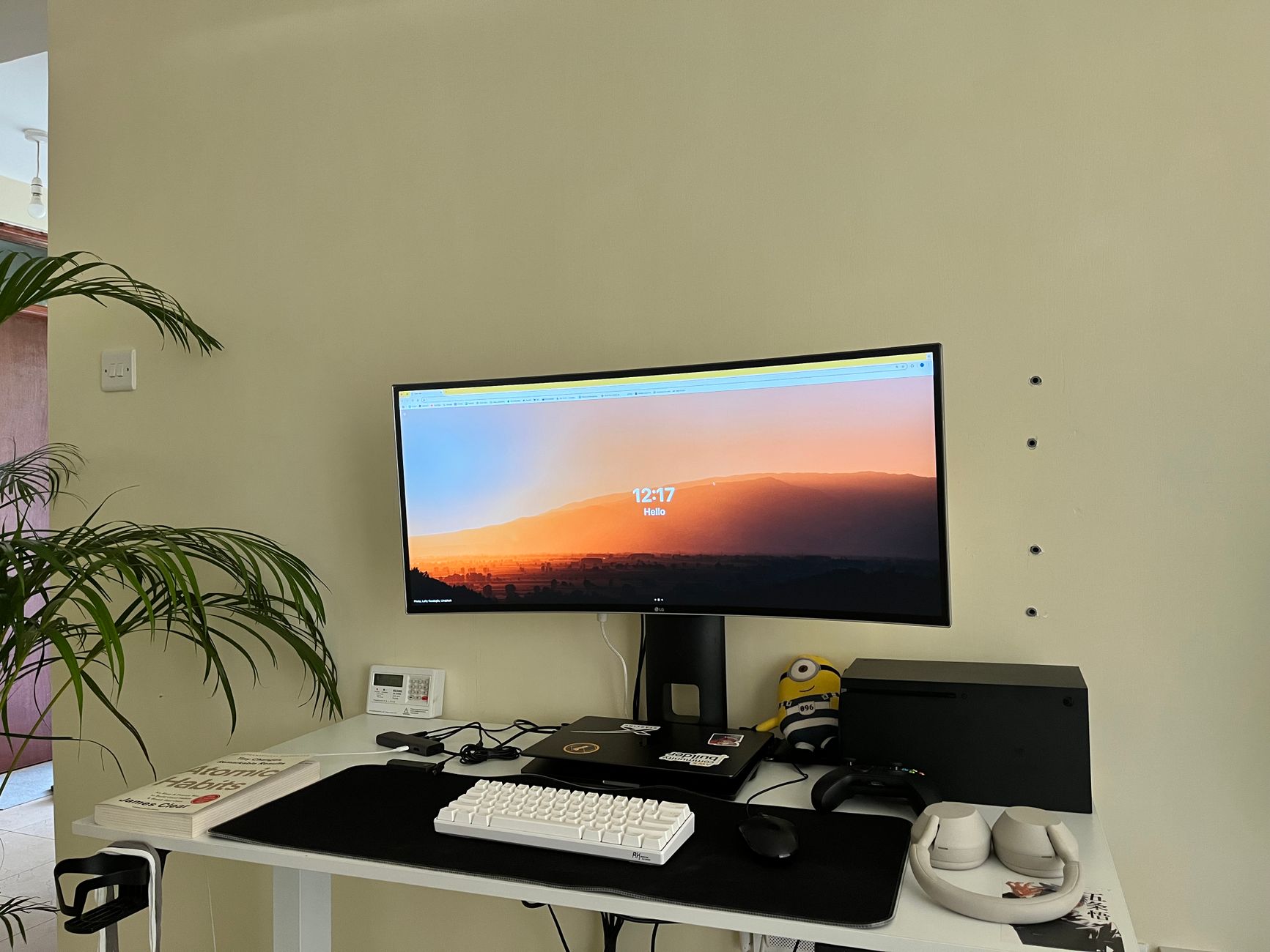 A modern home office setup in Nairobi with a curved monitor, desk, and accessories.