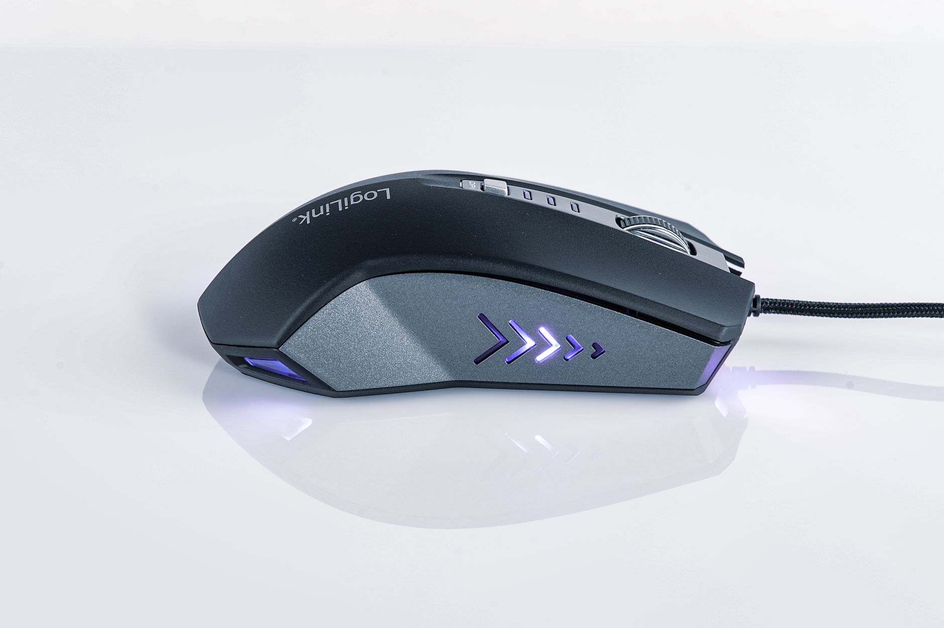 Close-up of a modern gaming mouse with LED lighting and ergonomic design on a sleek reflective background.