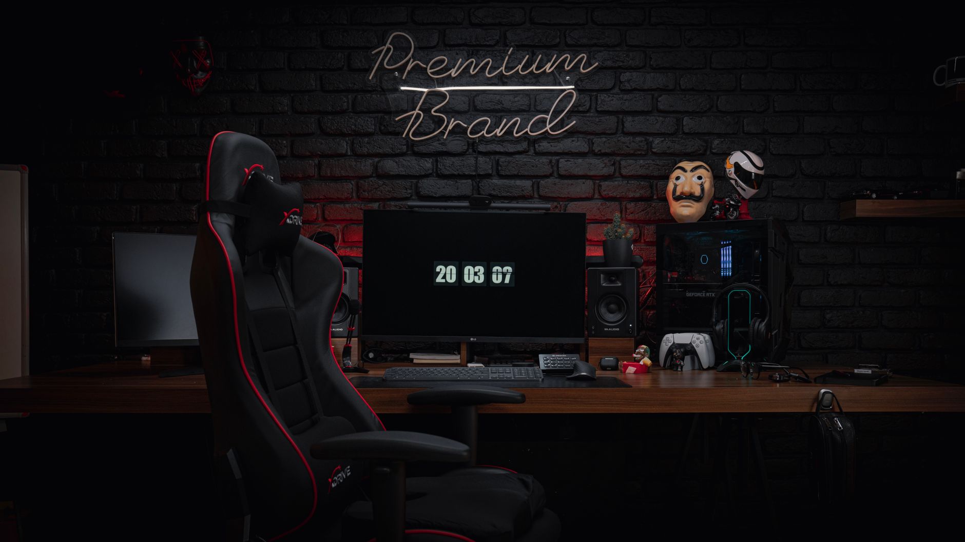 A sleek and contemporary gaming setup featuring a gaming chair, monitors, and modern tech against a black brick wall.