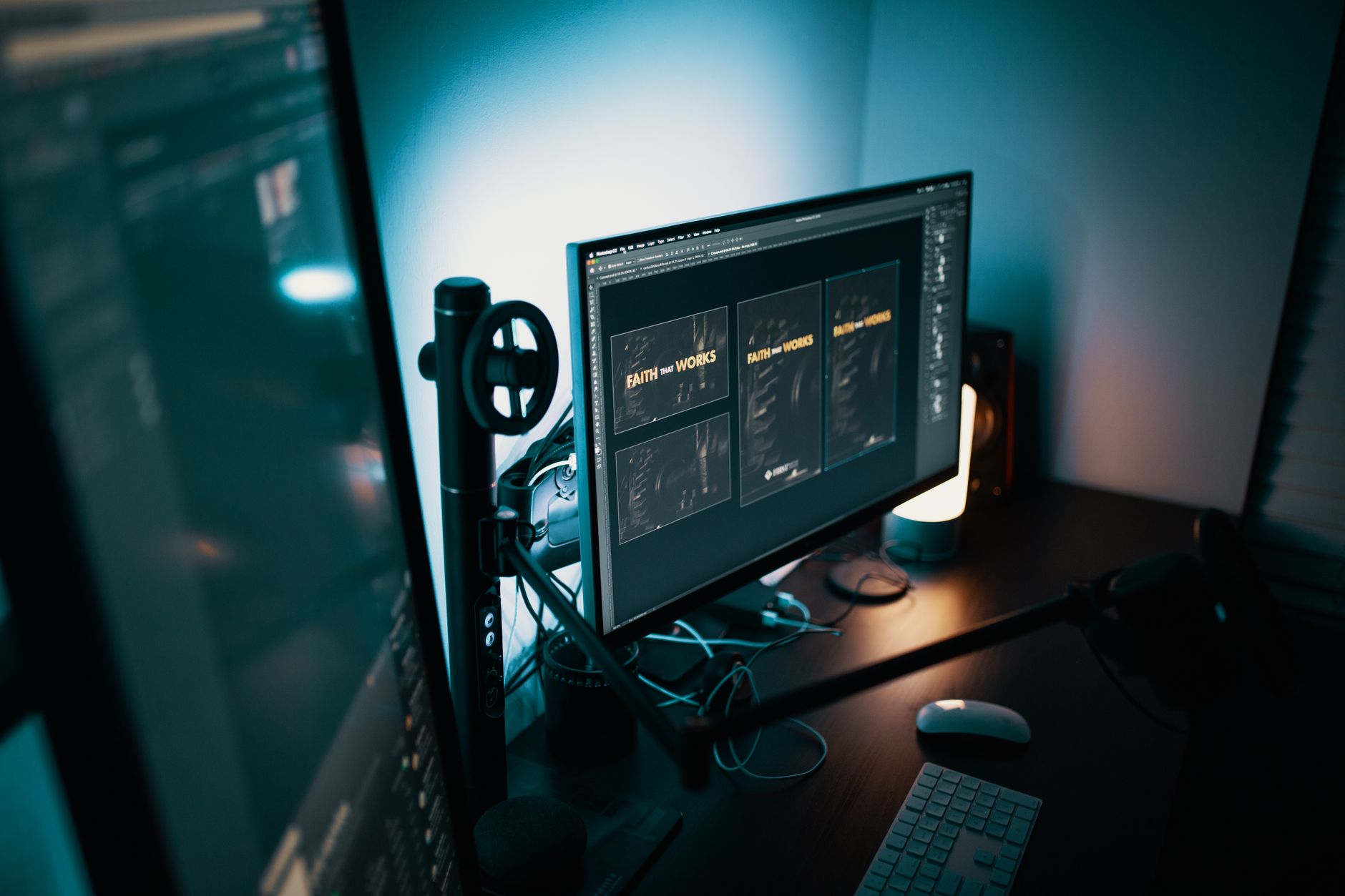 A stylish modern workspace with dual monitors displaying design software in a dimly lit room.