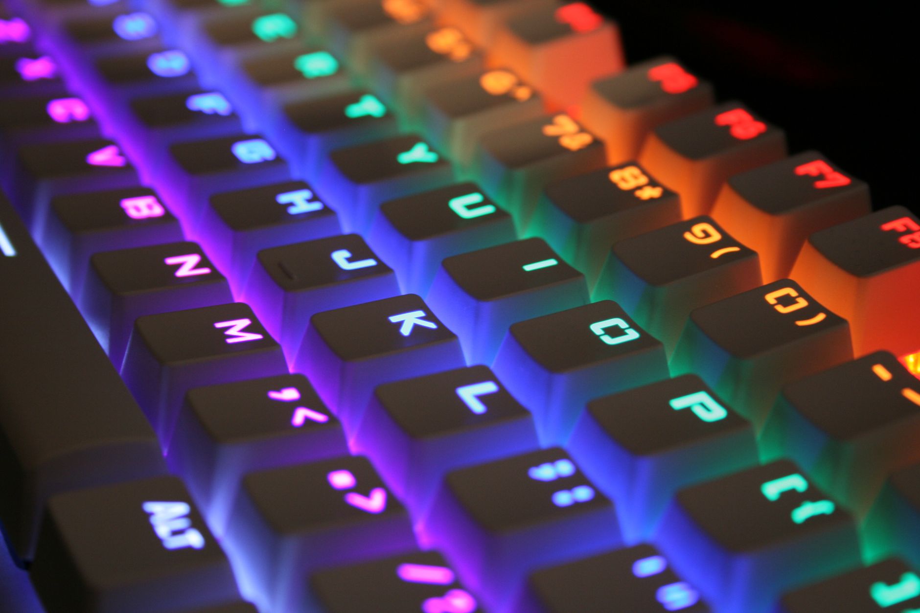 Close-up of a vibrant RGB gaming keyboard with illuminated keys.