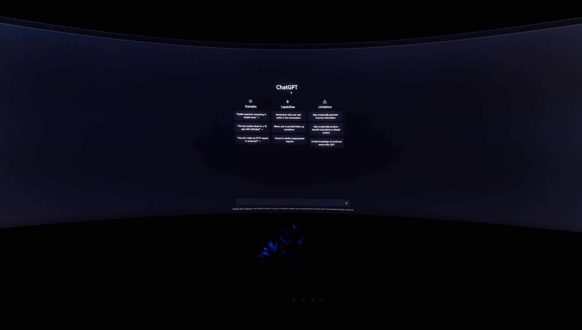 A dimly lit computer screen showing the ChatGPT interface in a dark setting.