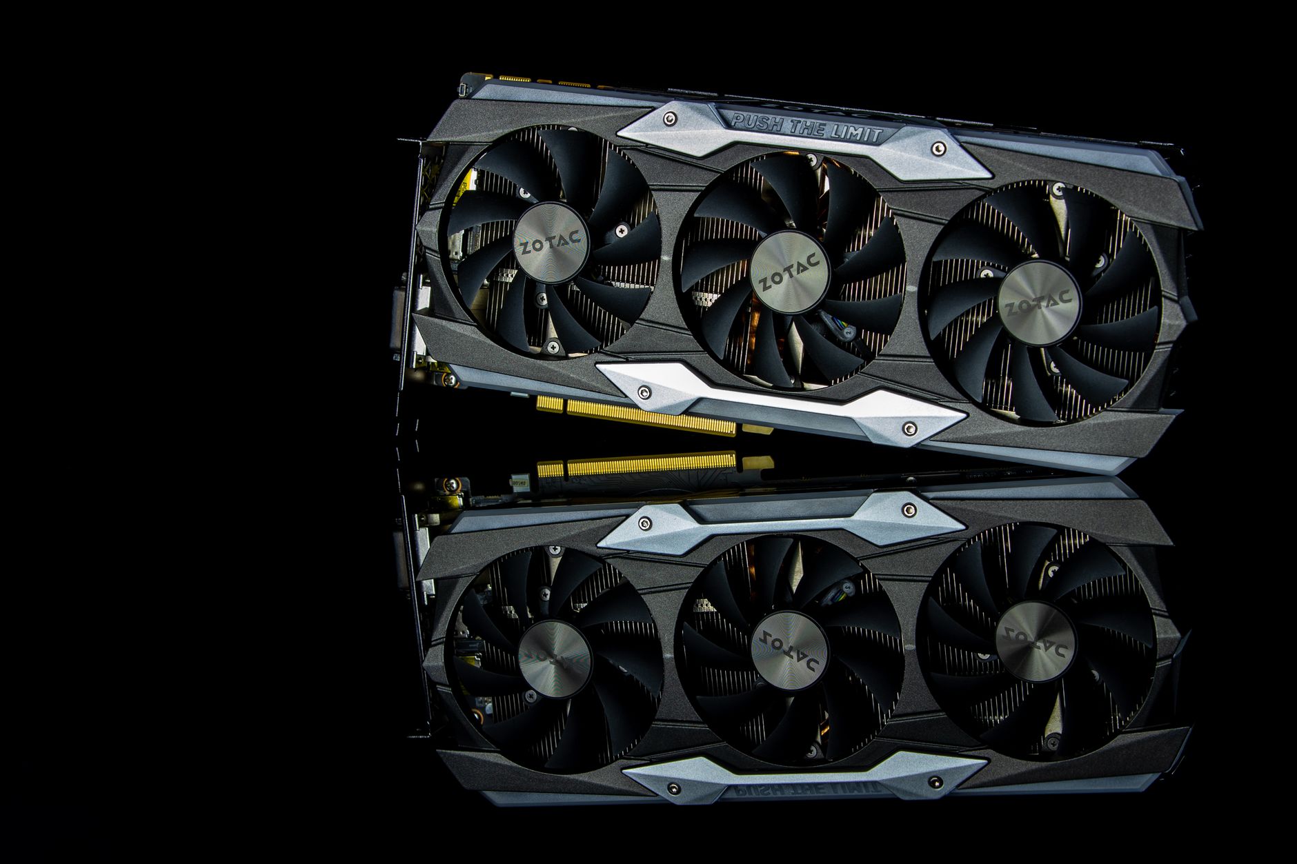 Close-up photo of a modern graphics card with cooling fans on a black background.