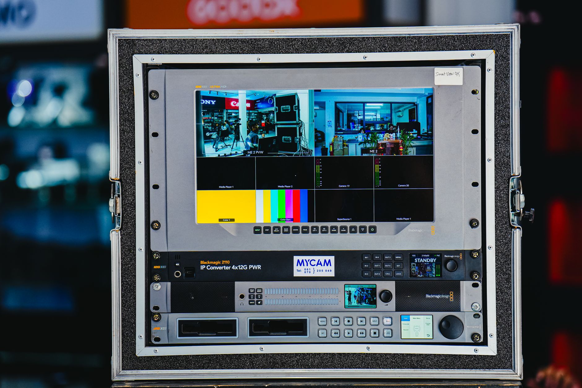 Close-up of a professional broadcast equipment panel displaying live feed from multiple cameras.