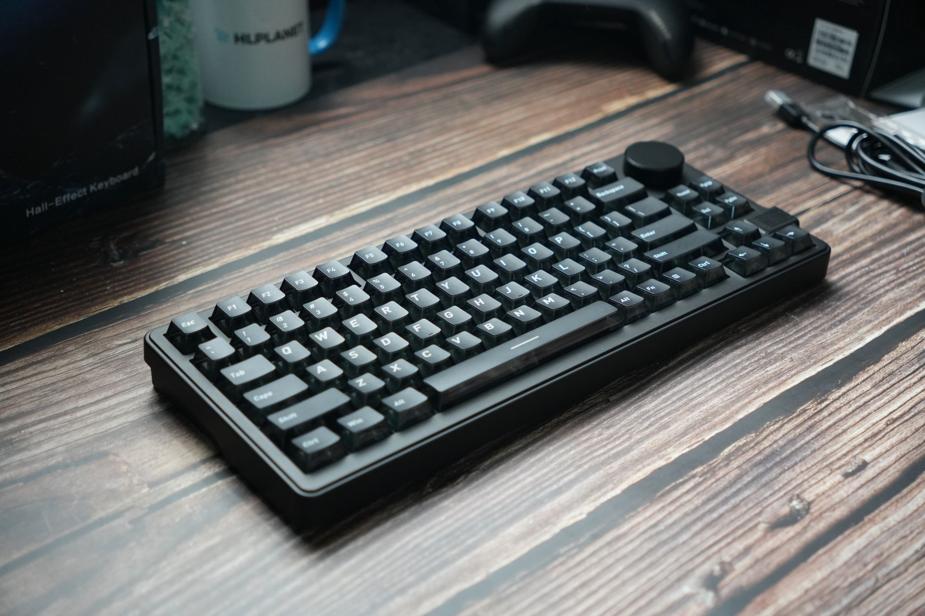 A sleek black mechanical keyboard placed on a wooden desk, ideal for gaming or office use.