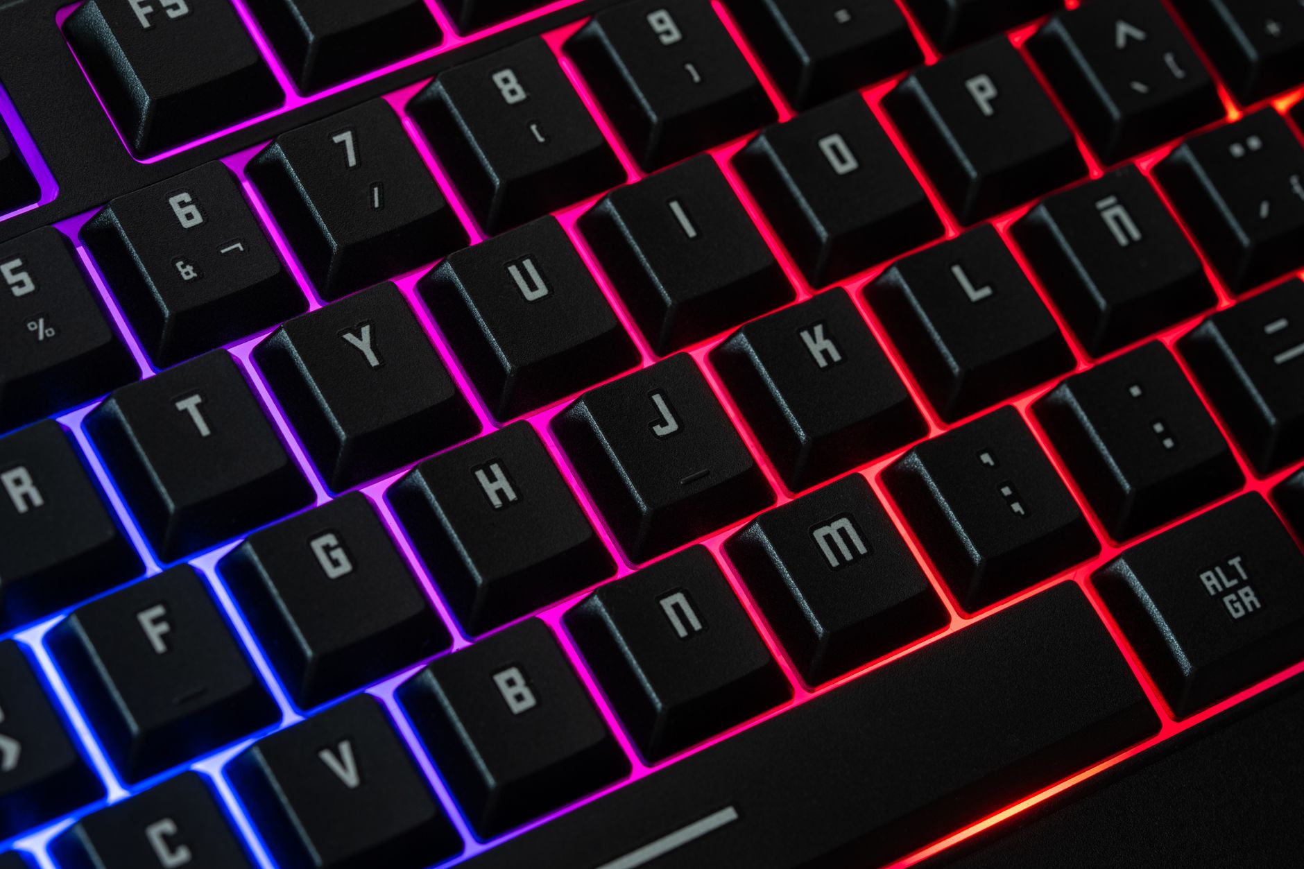 Vibrant RGB mechanical keyboard with neon lights, perfect for gaming and tech enthusiasts.