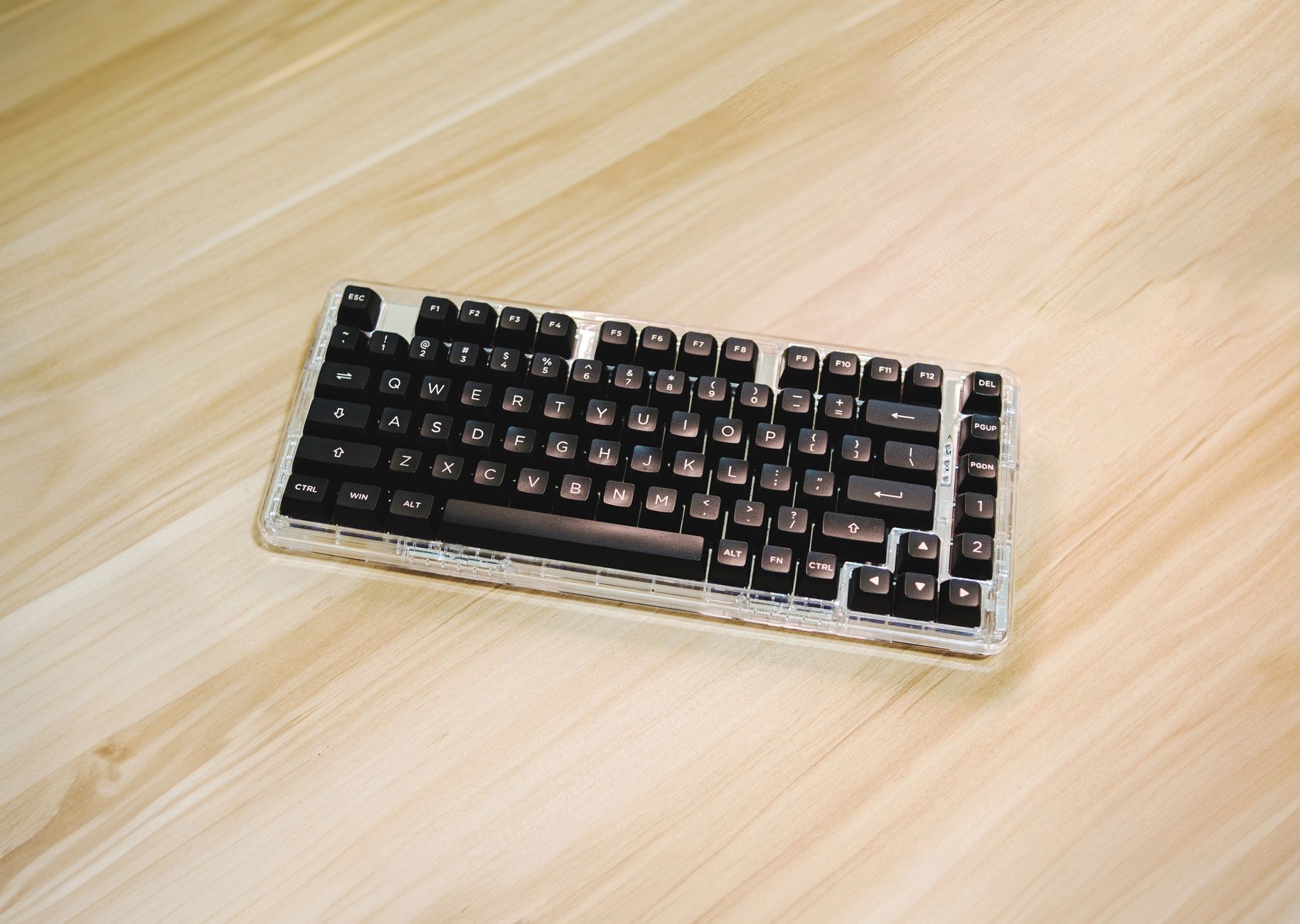 A modern mechanical keyboard placed on a clean wooden desk, highlighting minimalist design.